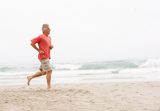 Older Man running along the beach